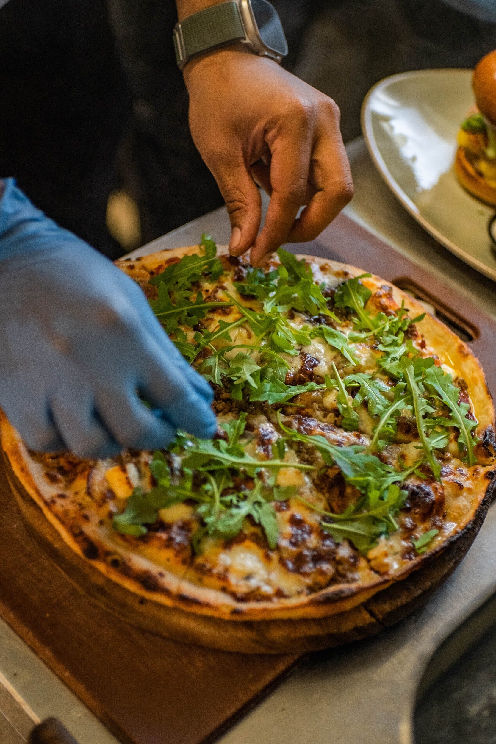 Bodega Eatery — wood-fired pizza finished with rocket